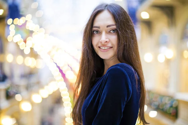 Young beautiful brunette woman in dark blue dress — Stock Photo, Image