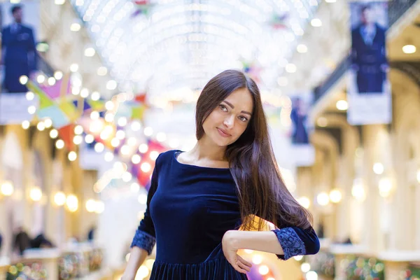 Young beautiful brunette woman in dark blue dress — Stock Photo, Image