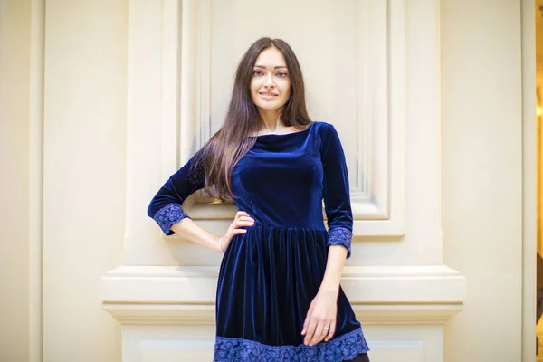 Young beautiful brunette woman in dark blue dress — Stock Photo, Image