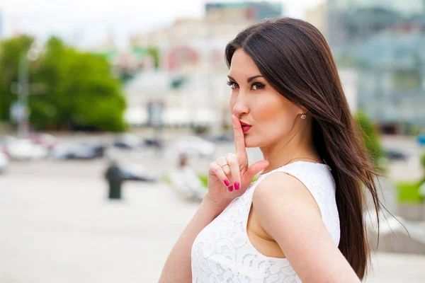 Young beautiful woman in a blue dress walking on the summer stre — Stock Photo, Image