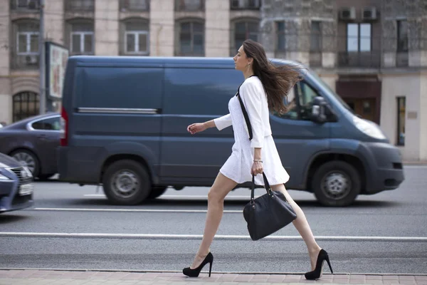 Ung vacker brunett kvinna i vita blommor klänning promenader på — Stockfoto