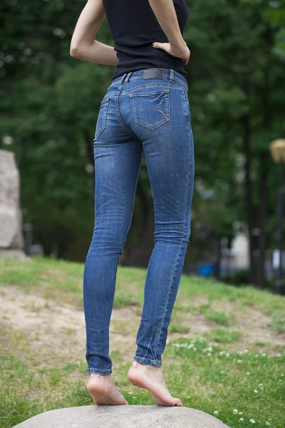 Back view of a long women legs posing with jeans — Stock Photo, Image