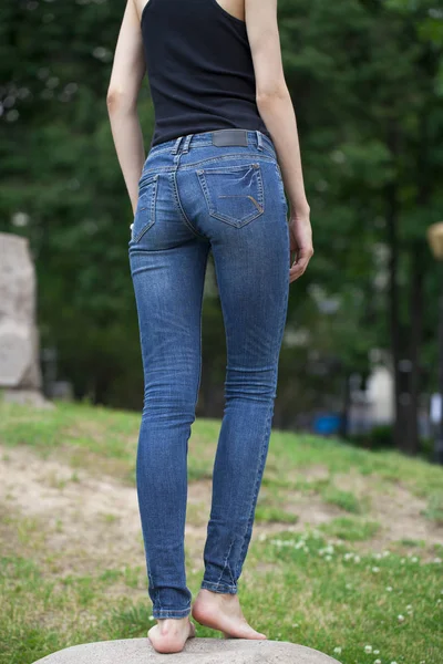 Вид сзади длинных женских ног, позирующих в джинсах — стоковое фото