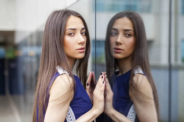 Stylish lady in blue dress posing near mirrored wall — Stock Photo, Image