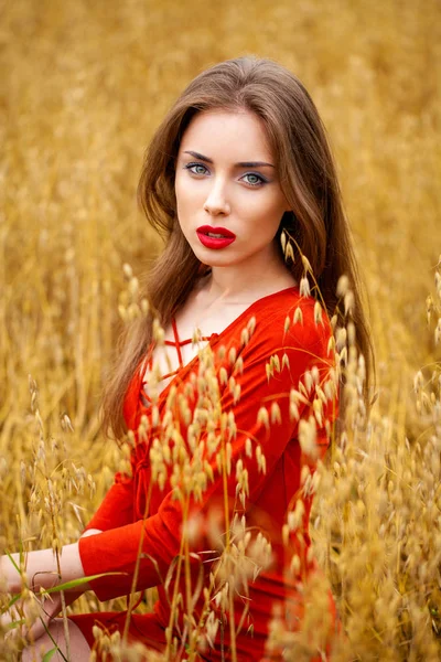 Portrait of a young brunette woman in red dress — Stock Photo, Image