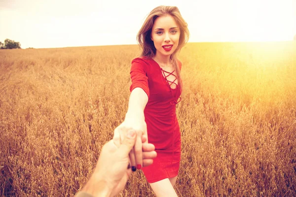 Follow me, Beautiful sexy young woman holds the hand of a man in — Stock Photo, Image