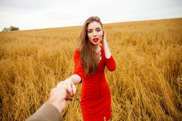 Follow me, Beautiful sexy young woman holds the hand of a man in — Stock Photo, Image