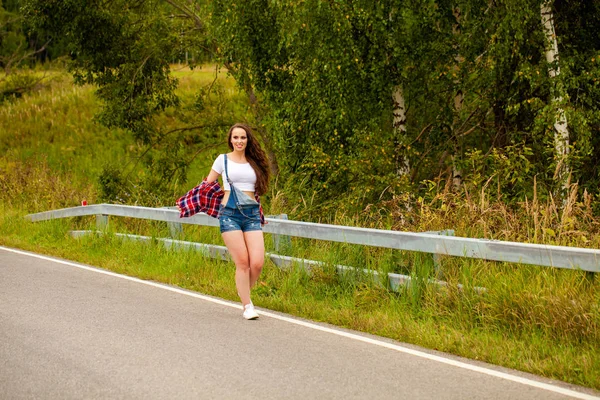 Young beautiful brown haired woman in blue jeans — Stock Photo, Image