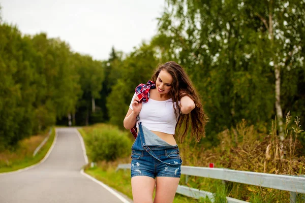 Young beautiful brown haired woman in blue jeans — Stock Photo, Image