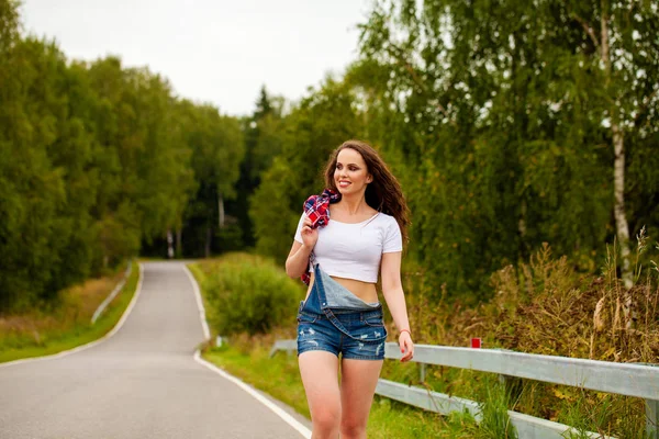 Young beautiful brown haired woman in blue jeans — Stock Photo, Image