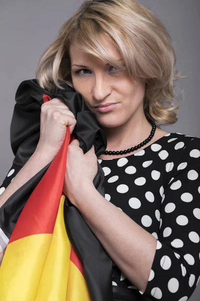 Beautiful woman wrapped in the German flag — Stock Photo, Image