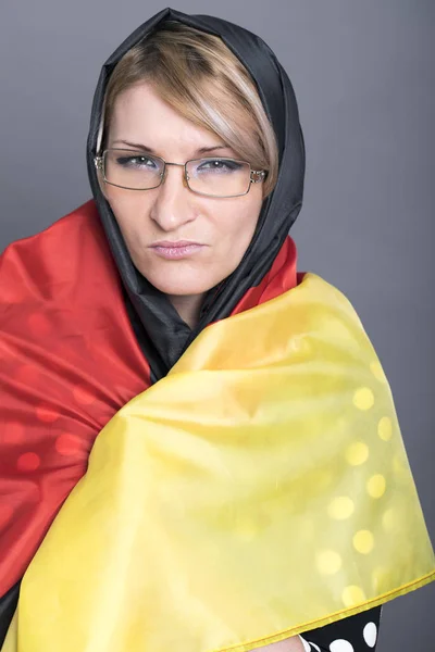 Beautiful woman wrapped in the German flag — Stock Photo, Image
