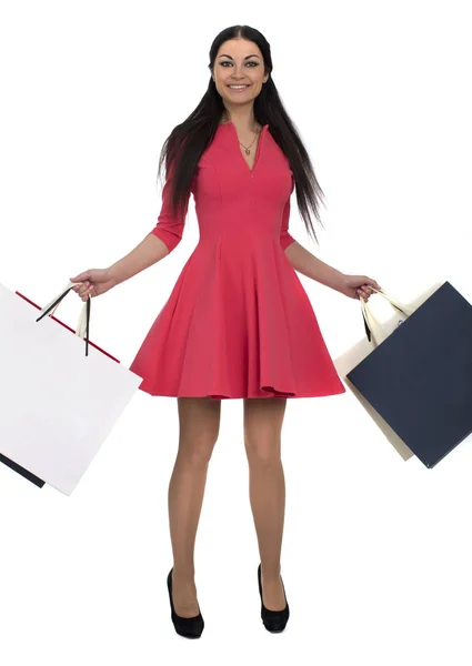 Mujer morena joven con algunas bolsas de compras —  Fotos de Stock