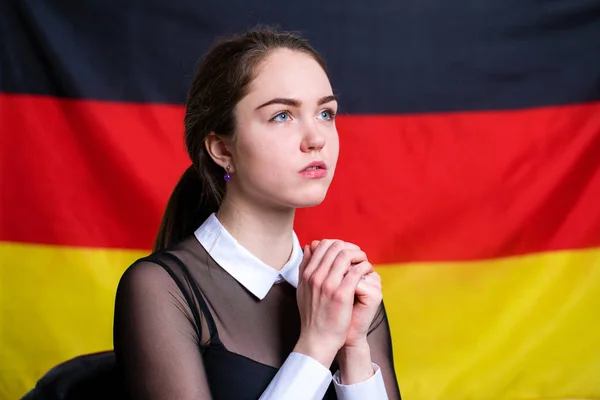 Гарна спокійна брюнетка дівчина на тлі німецького fla — стокове фото