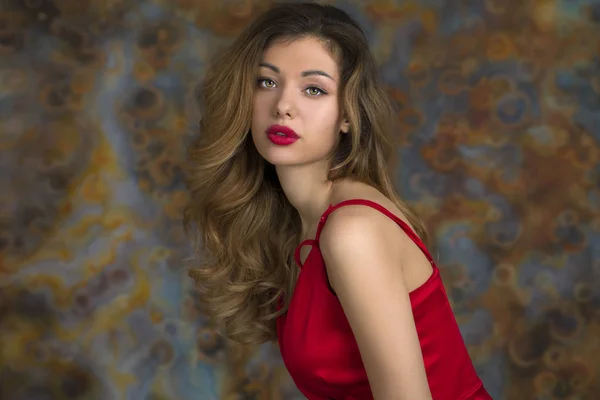 Young beautiful blonde woman in red dress — Stock Photo, Image