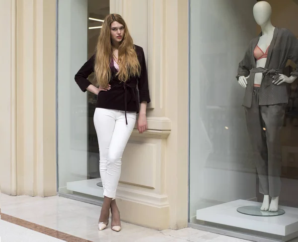 Beautiful blonde woman in white pants and corduroy jacket