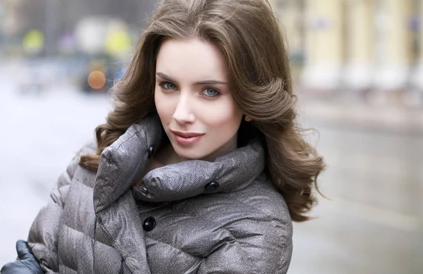 Retrato de una joven morena con estilo en una chaqueta gris —  Fotos de Stock