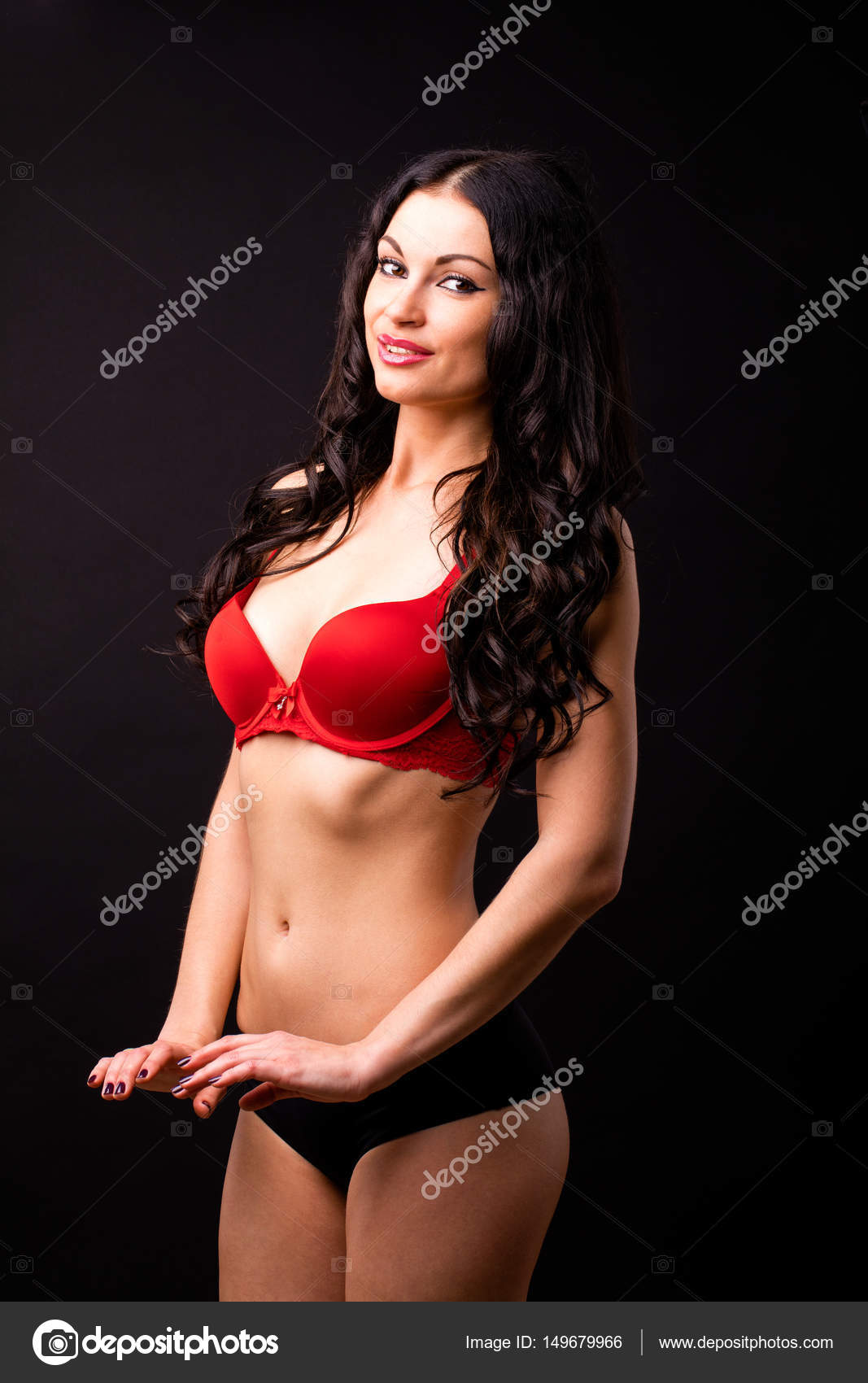 Portrait of sexy brunette woman in red and black underwear on a