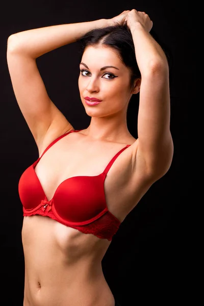 Portrait of sexy brunette woman in red and black underwear on a — Stock Photo, Image