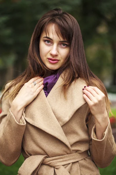 Portrait of a young beautiful woman in beige coat — Stock Photo, Image