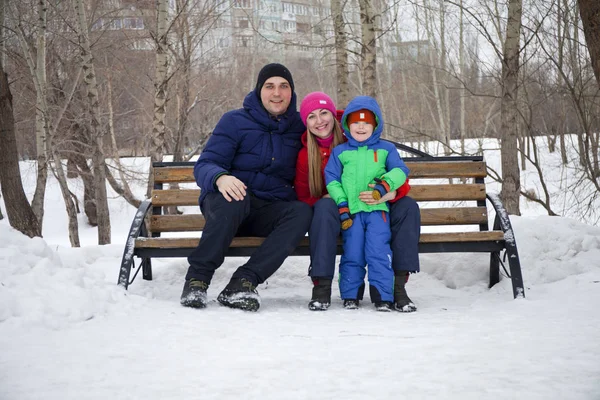 Young family spending time outdoor in winter — Stock Photo, Image