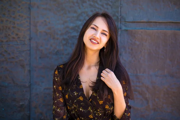 Beautiful brunette woman in sexy brown dress — Stock Photo, Image