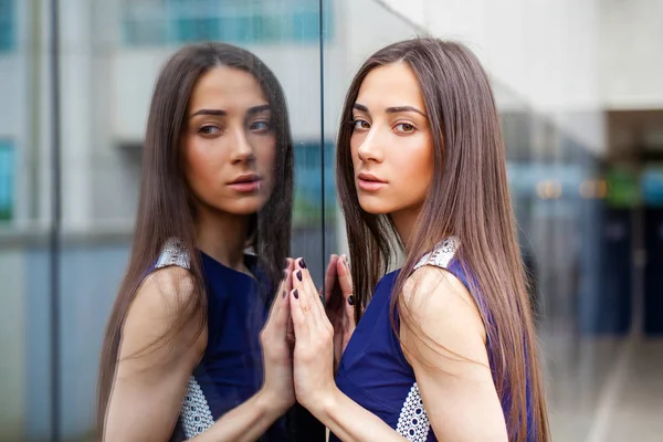 Stylish lady in blue dress posing near mirrored wall — Stock Photo, Image