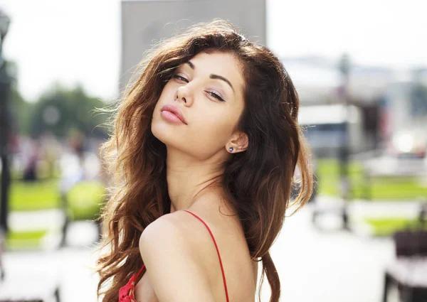 Beautiful brunette woman in sexy red dress — Stock Photo, Image