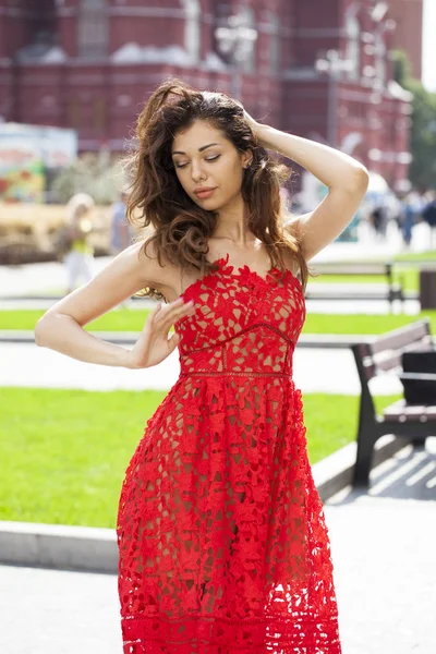 Beautiful brunette woman in sexy red dress — Stock Photo, Image