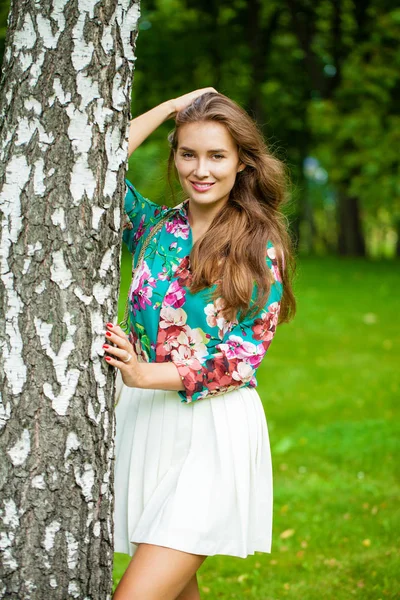 Young brunette woman in white skirt — Stock Photo, Image