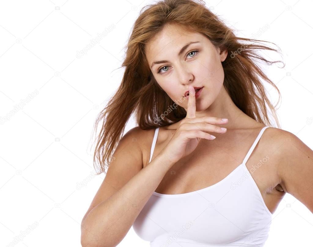 Young beautiful blonde woman has put forefinger to lips as sign 
