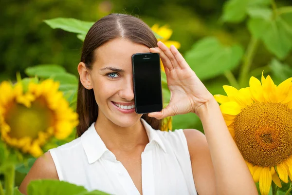 Fiatal gyönyörű lány a smartphone képernyő bemutatás — Stock Fotó