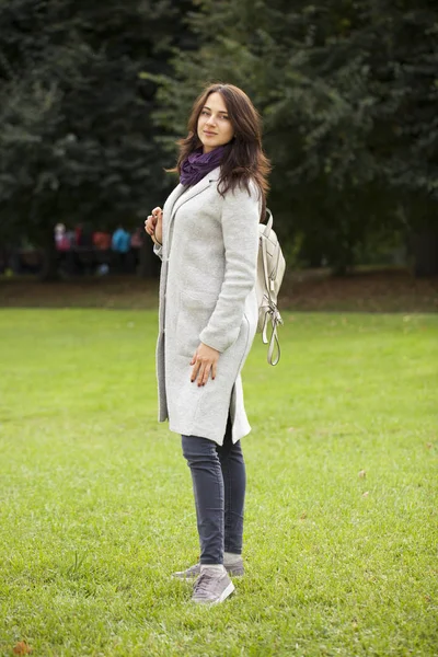 Portrait of a young beautiful woman in gray coat — Stock Photo, Image