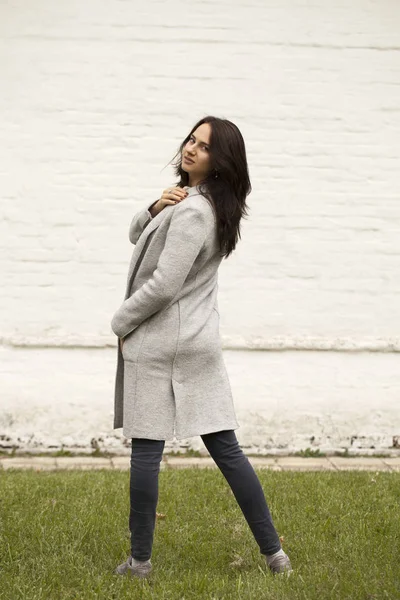 Brunette woman in a gray woolen coat — Stock Photo, Image