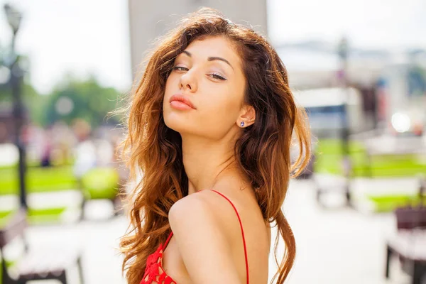 Beautiful brunette woman in sexy red dress — Stock Photo, Image