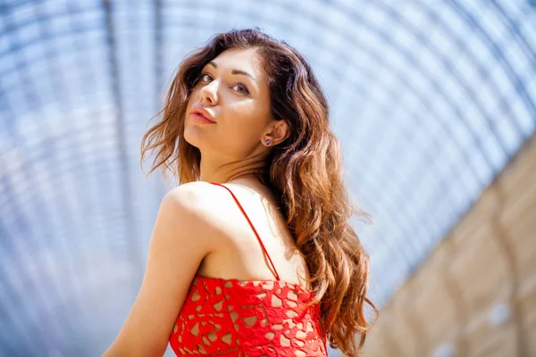 Beautiful brunette woman in pink dress — Stock Photo, Image