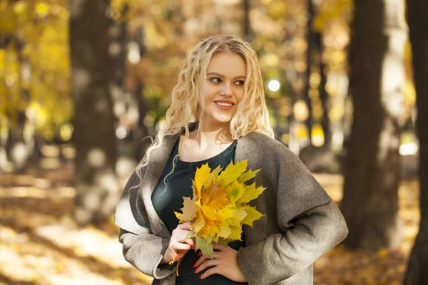 Portrait of a young beautiful woman in gray coat — Stock Photo, Image