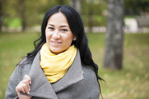 Portrait of a young beautiful woman in gray coat — Stock Photo, Image