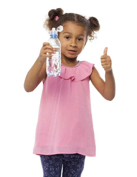 Little mulatto african girl drinks water from a bottle — Stock Photo, Image