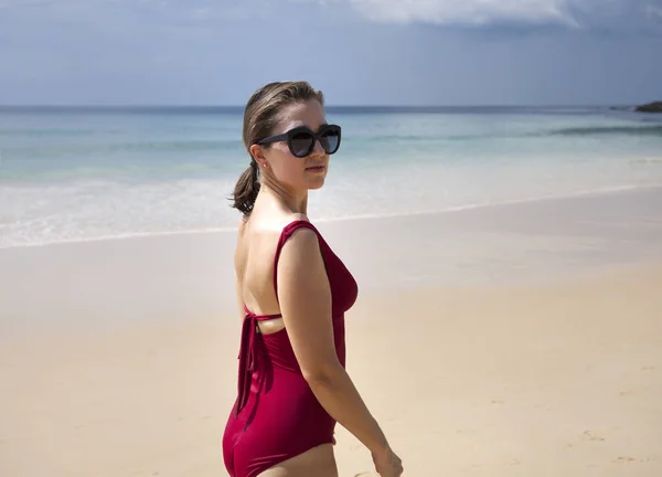 Portrait of a young woman in a red solid swimsuit — Stock Photo, Image