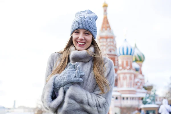 Portrait of a young woman in a blue knitted hat and gray mink co — Stock Photo, Image