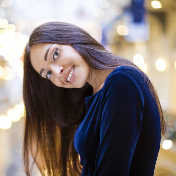 Young beautiful brunette woman in dark blue dress — Stock Photo, Image