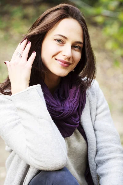 Portrait of a young beautiful woman in gray coat — Stock Photo, Image