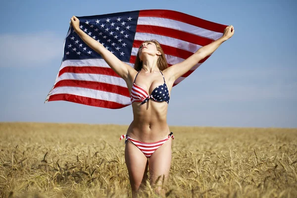 Sexy woman in sexy American flag bikini in a wheat field — Stock Photo, Image