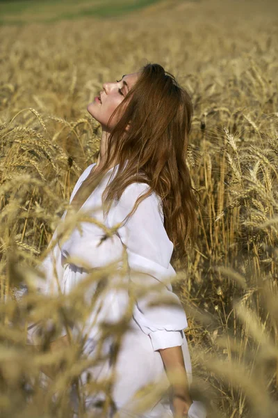 Portrait of a young sexy blonde woman on a background of golden — Stock Photo, Image