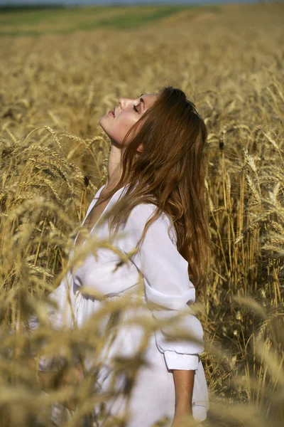 Portrait of a young sexy blonde woman on a background of golden — Stock Photo, Image