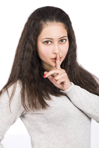 Young beautiful woman has put forefinger to lips as sign of sile — Stock Photo, Image