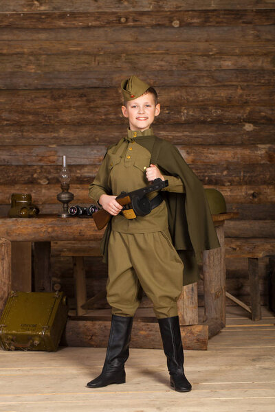 Russian boy in the old-fashioned Soviet military uniform 