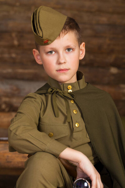 Russian boy in the old-fashioned Soviet military uniform 