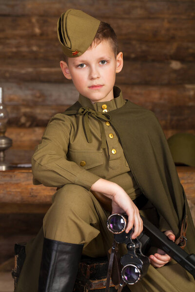 Russian boy in the old-fashioned Soviet military uniform 